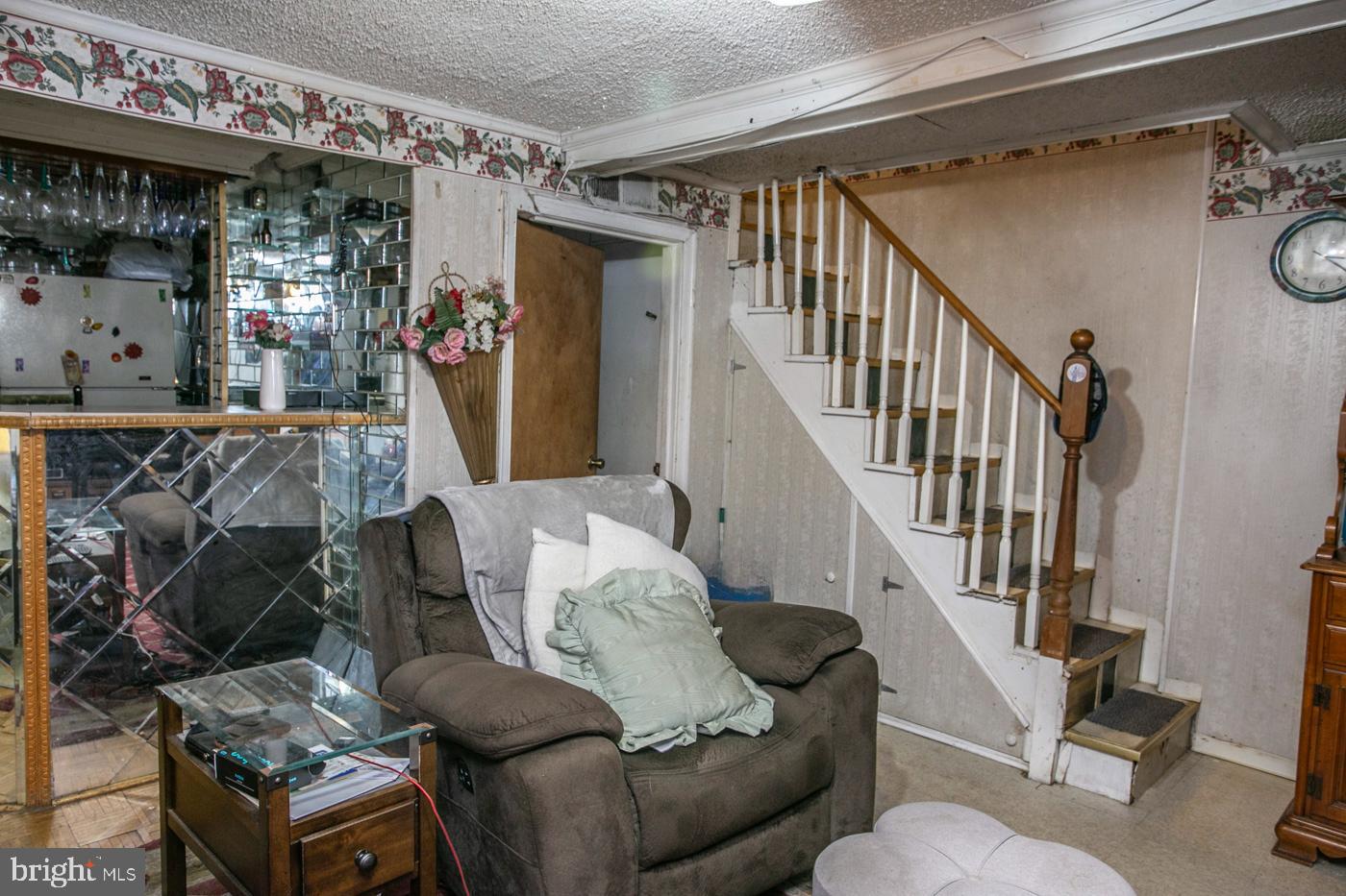 1144 Slocum Street Philadelphia, PA 19150 - Photo 22 of 27 a living room with furniture and a chandelier