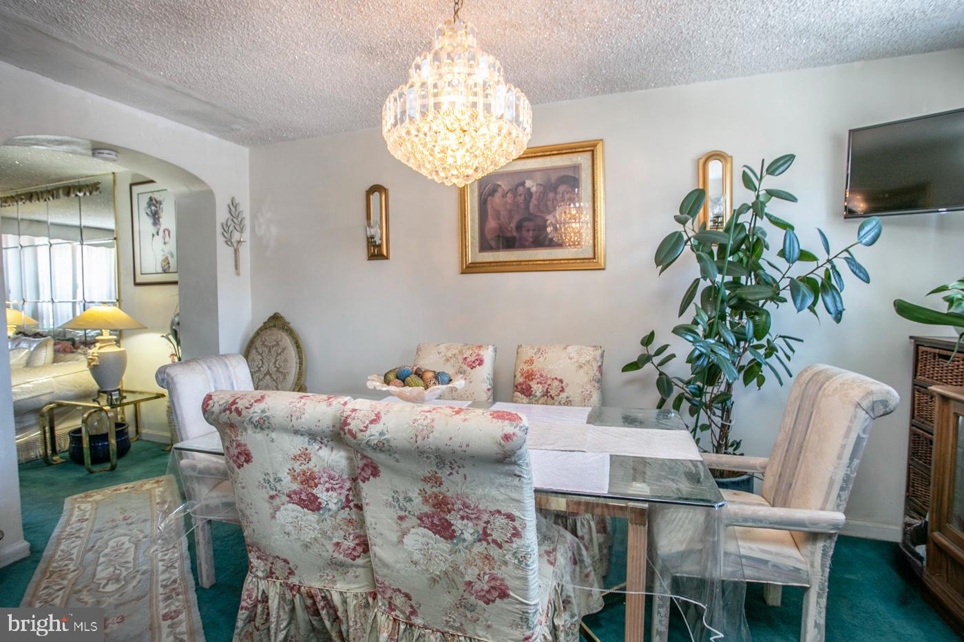 1144 Slocum Street Philadelphia, PA 19150 - Photo 8 of 27 a bedroom with furniture and a chandelier