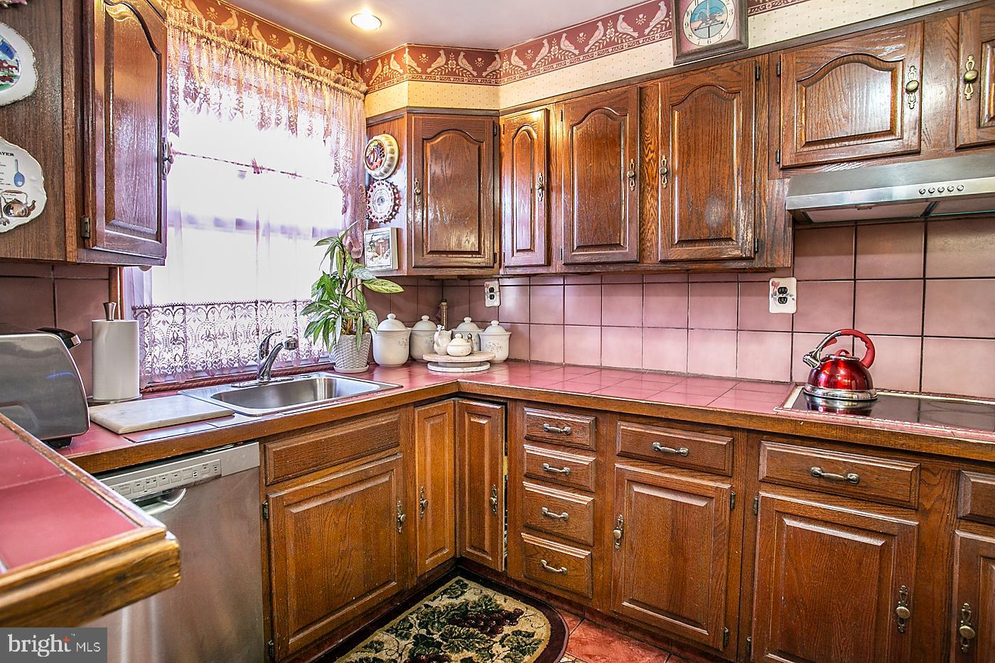 1144 Slocum Street Philadelphia, PA 19150 - Photo 10 of 27 a kitchen with stainless steel appliances granite countertop a sink and cabinets