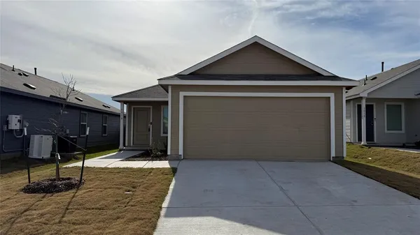 a front view of a house with parking space