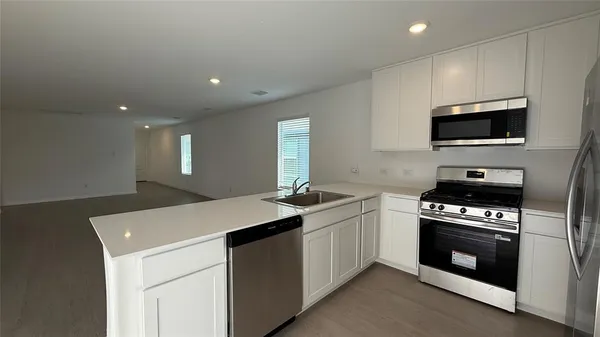 a kitchen with a sink stove and microwave