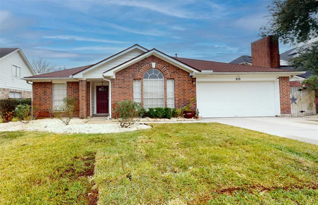 a view of a house with a yard and garage
