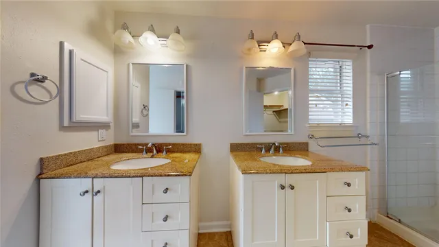 a bathroom with double sink and a mirror