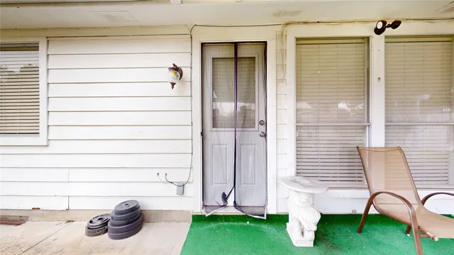 a view of a two chairs in front of door