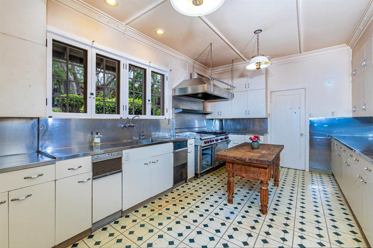 300 Kepa Road Kula, HI 96790 - Photo 28 of 30 a kitchen with granite countertop a sink a counter space appliances and cabinets