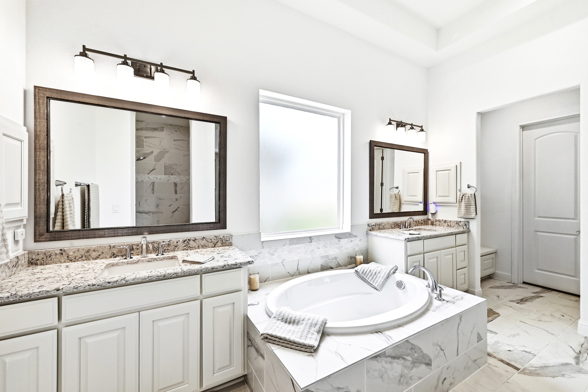 4601 Apollonia Way Leander, TX 78641 - Photo 16 of 40 a bathroom with a granite countertop sink mirror and a bathtub