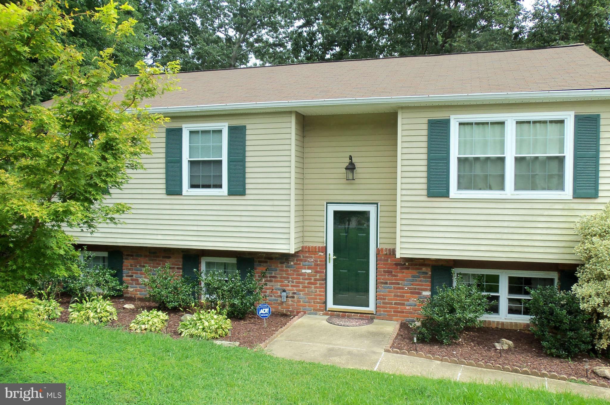 a house that has a tree in front of it