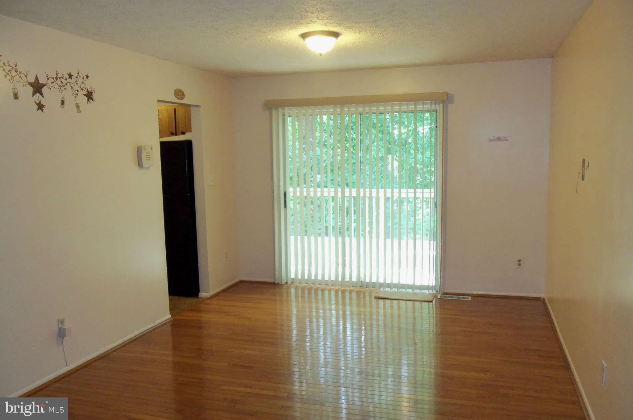 271 Silverleaf Court Arnold, MD 21012 - Photo 4 of 19 a view of an empty room with wooden floor and a window