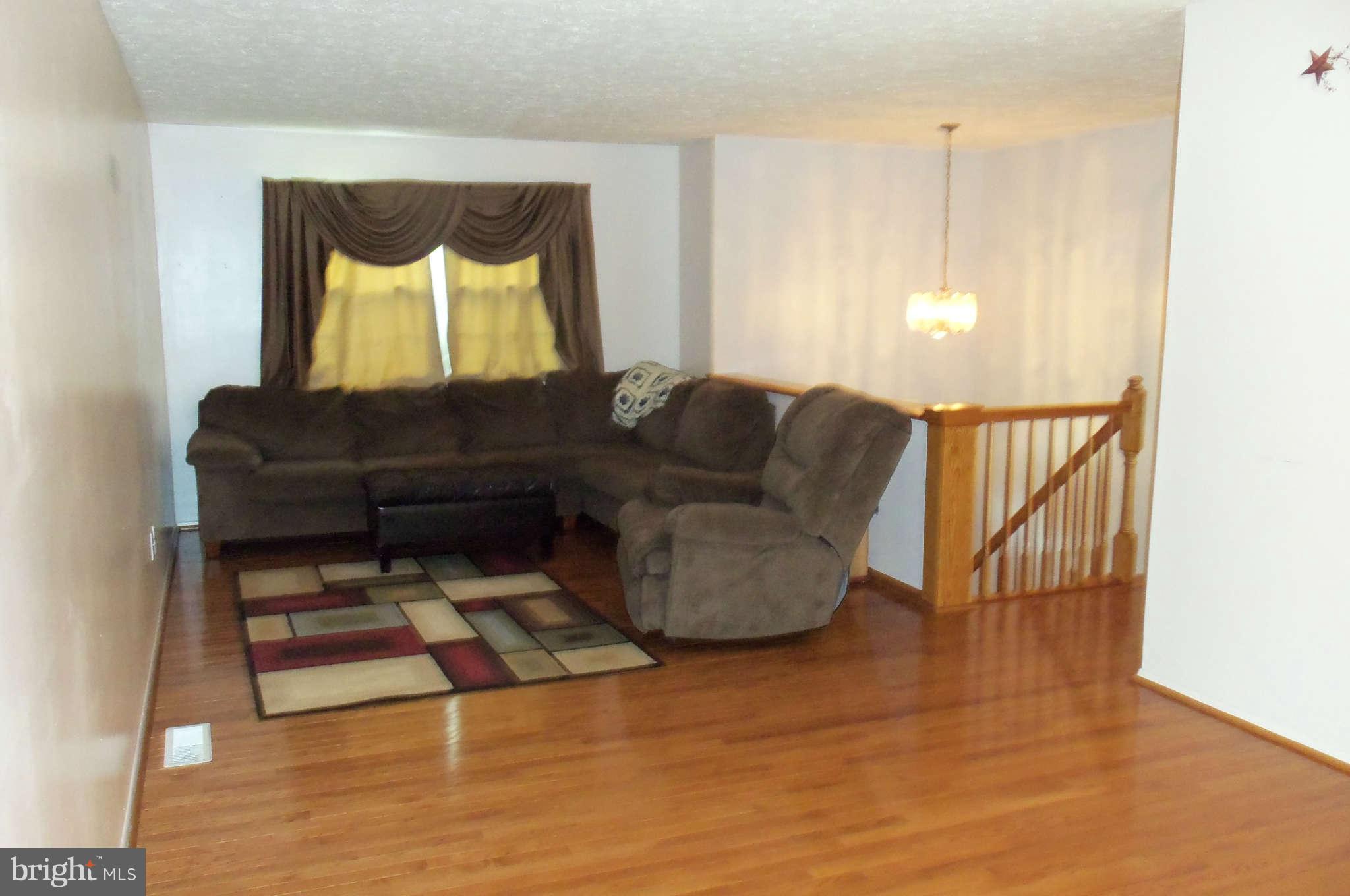 271 Silverleaf Court Arnold, MD 21012 - Photo 5 of 19 a living room with furniture and a painting on the wall