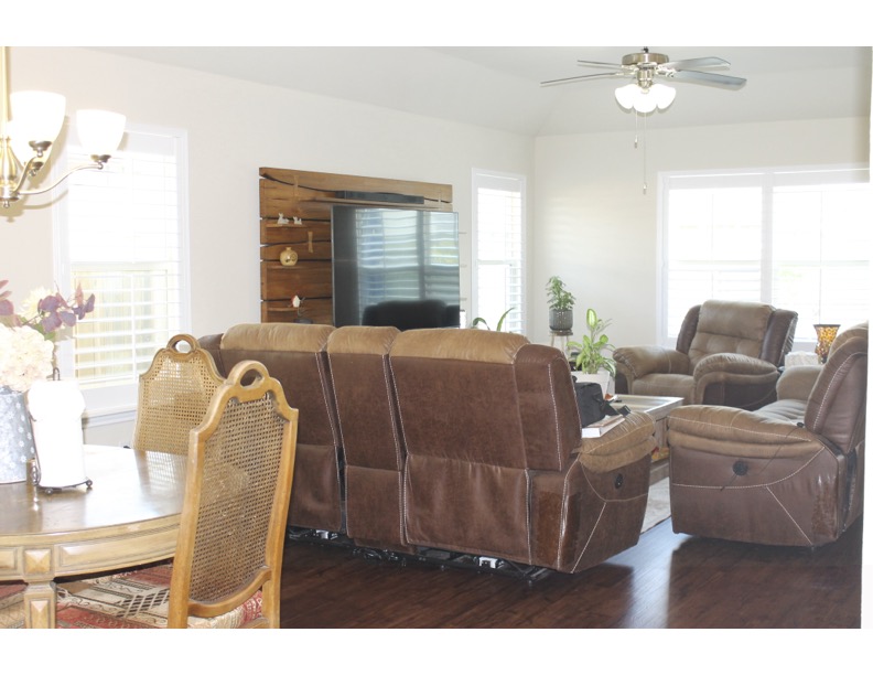 188 Beth Ann Loop Taylor, TX 76574 - Photo 2 of 12 Hardwood flooring and high ceilings grace this inviting, sun-filled living area.