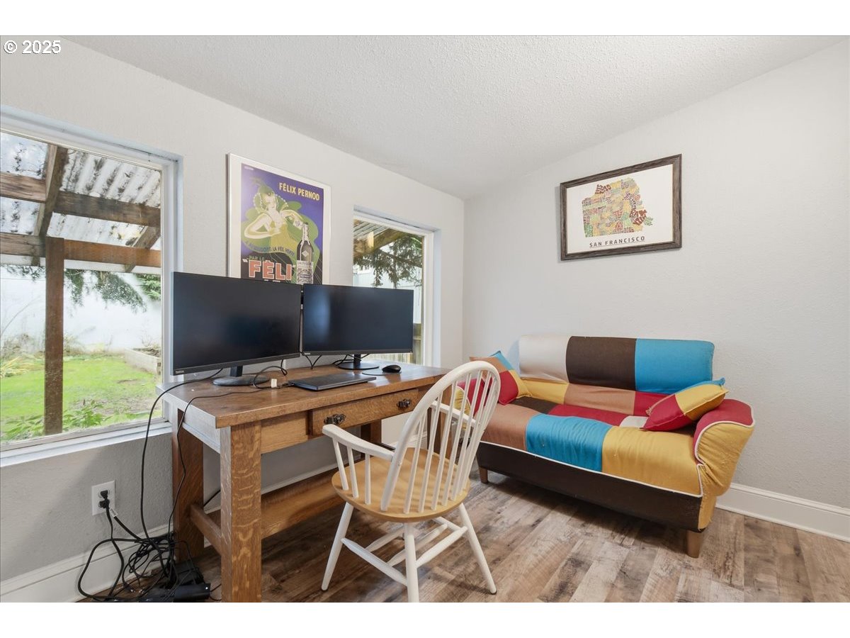 8813 Northeast Ward Street Portland, OR 97220 - Photo 11 of 32 a workspace with furniture and a flat screen tv
