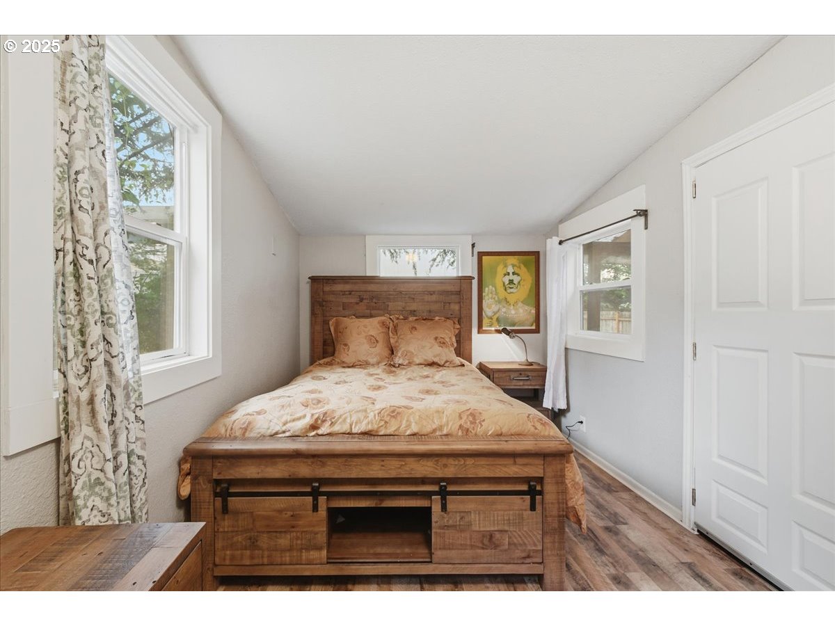 8813 Northeast Ward Street Portland, OR 97220 - Photo 12 of 32 a bedroom with a bed and a window