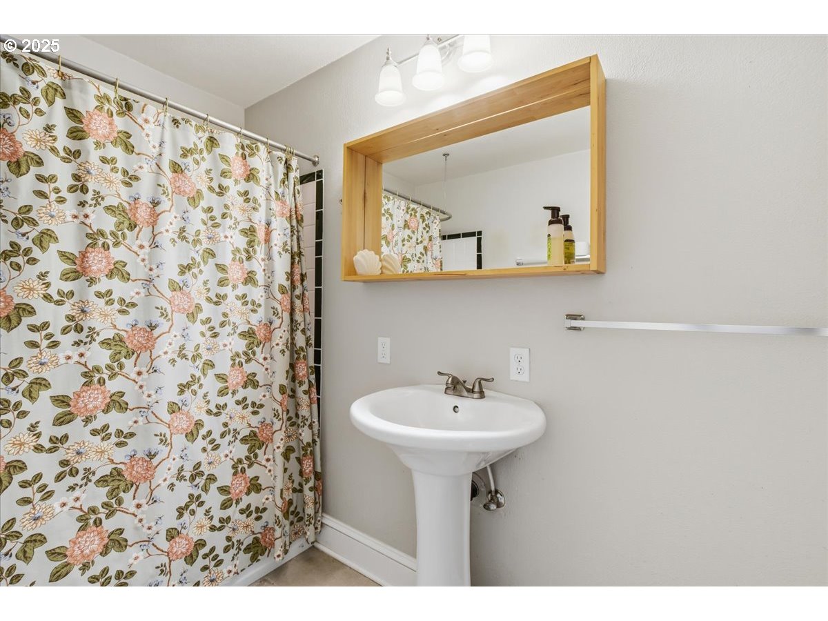 8813 Northeast Ward Street Portland, OR 97220 - Photo 17 of 32 a bathroom with a sink and a mirror