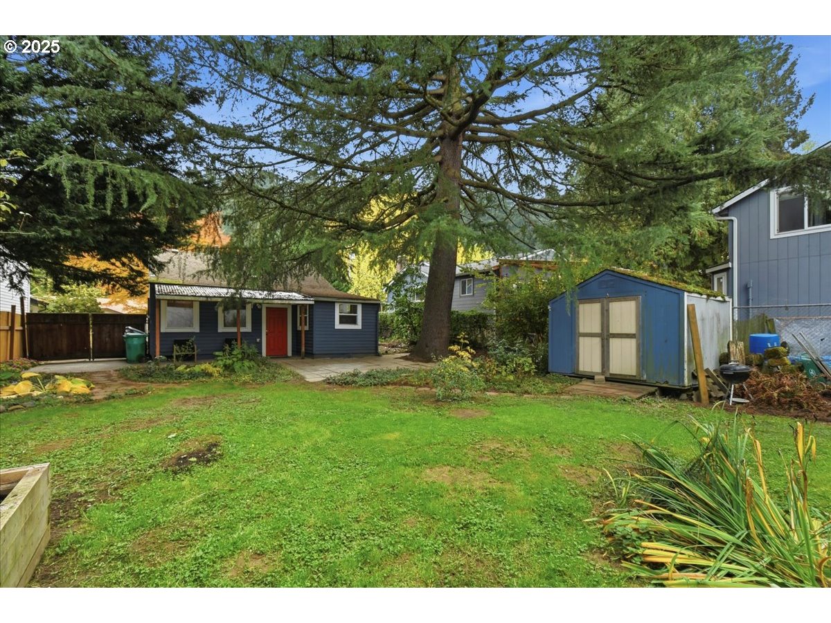 8813 Northeast Ward Street Portland, OR 97220 - Photo 20 of 32 a view of a big yard with plants and large trees