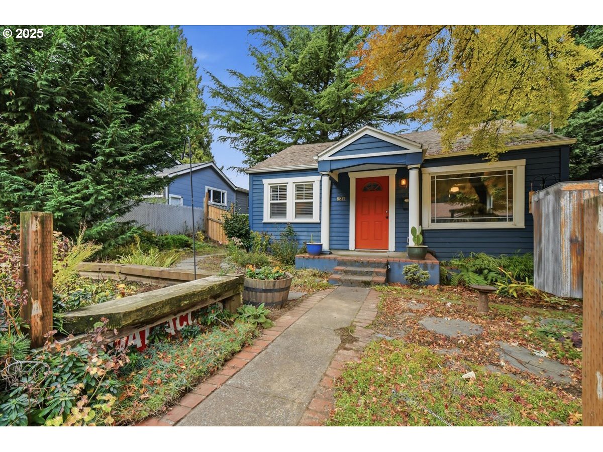 8813 Northeast Ward Street Portland, OR 97220 - Photo 2 of 32 a front view of a house with a garden