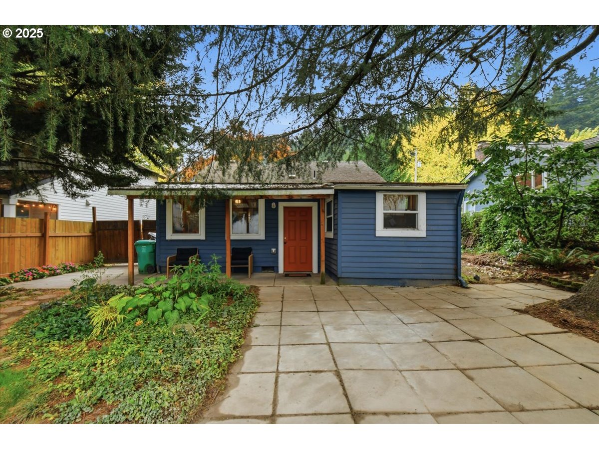 8813 Northeast Ward Street Portland, OR 97220 - Photo 22 of 32 a view of a house with a large tree and a yard in front of it