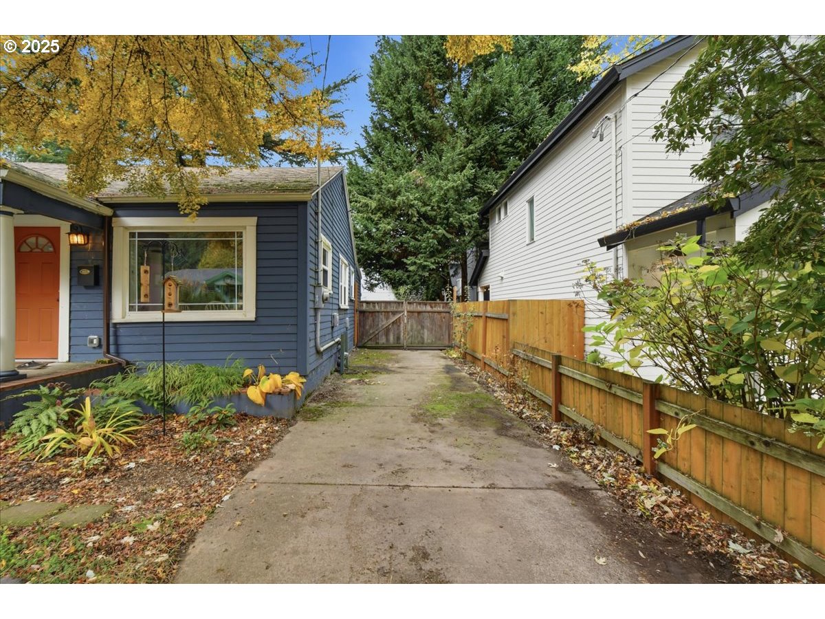8813 Northeast Ward Street Portland, OR 97220 - Photo 25 of 32 a view of a house with a small yard and a large tree