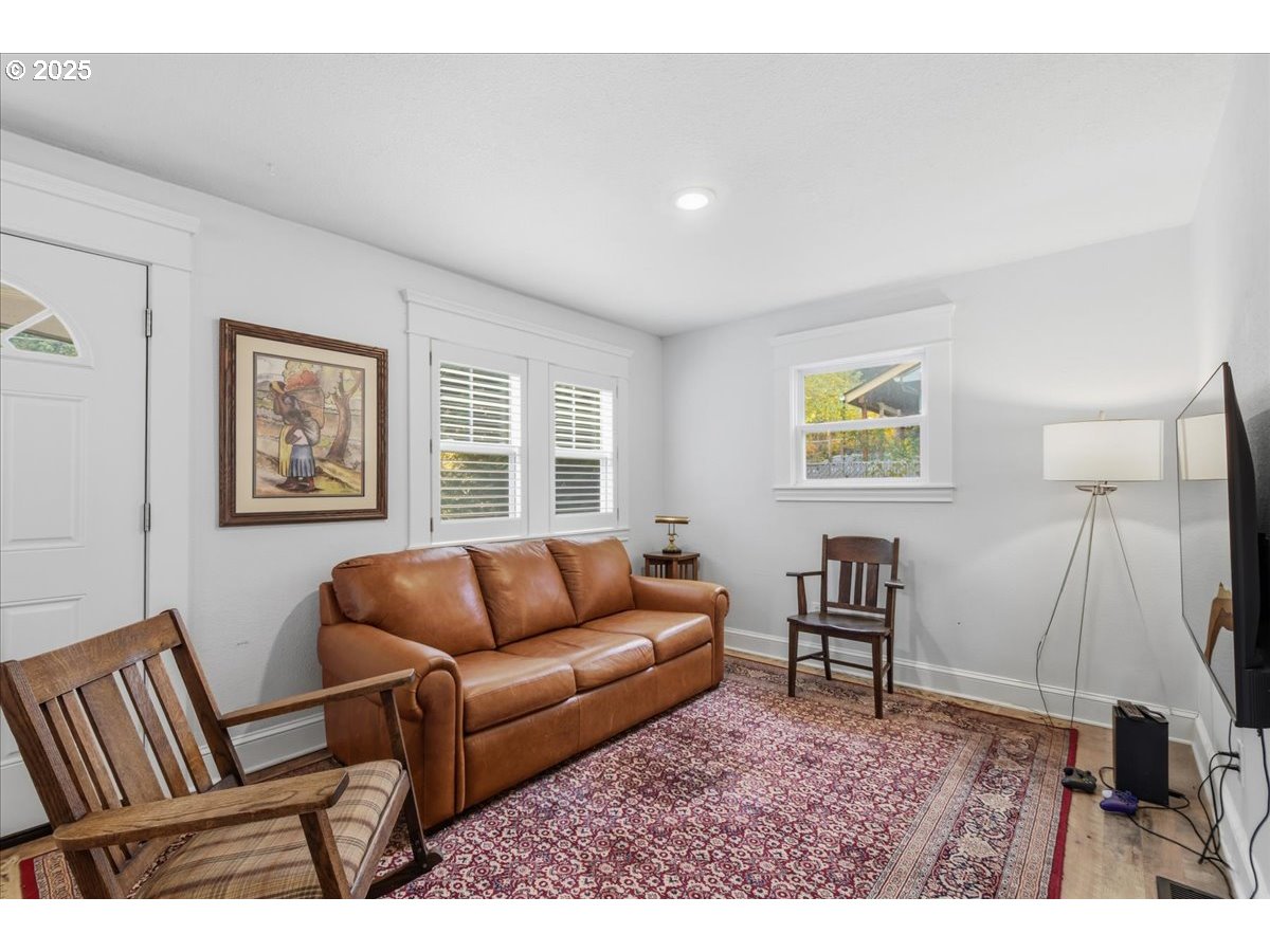8813 Northeast Ward Street Portland, OR 97220 - Photo 5 of 32 a living room with furniture and a flat screen tv