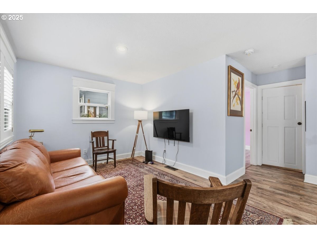 8813 Northeast Ward Street Portland, OR 97220 - Photo 6 of 32 a living room with furniture and a flat screen tv