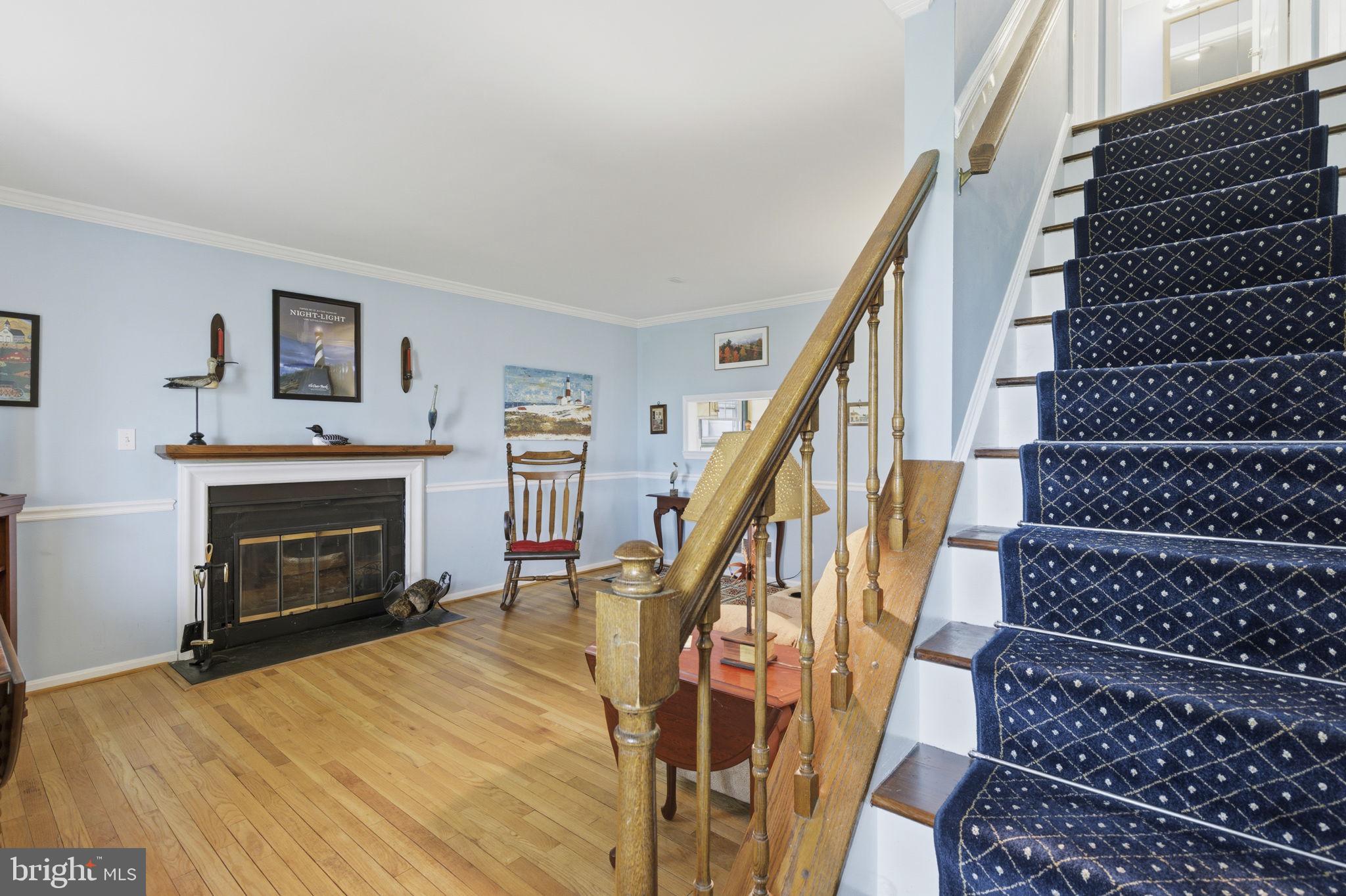 3831 Wilkinson Road Havre de Grace, MD 21078 - Photo 3 of 51 a view of an empty room with wooden floor fireplace and stairs