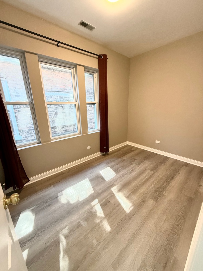 4357 South Whipple Street, Unit 2 Chicago, IL 60632 - Photo 7 of 17 a view of an empty room with a window