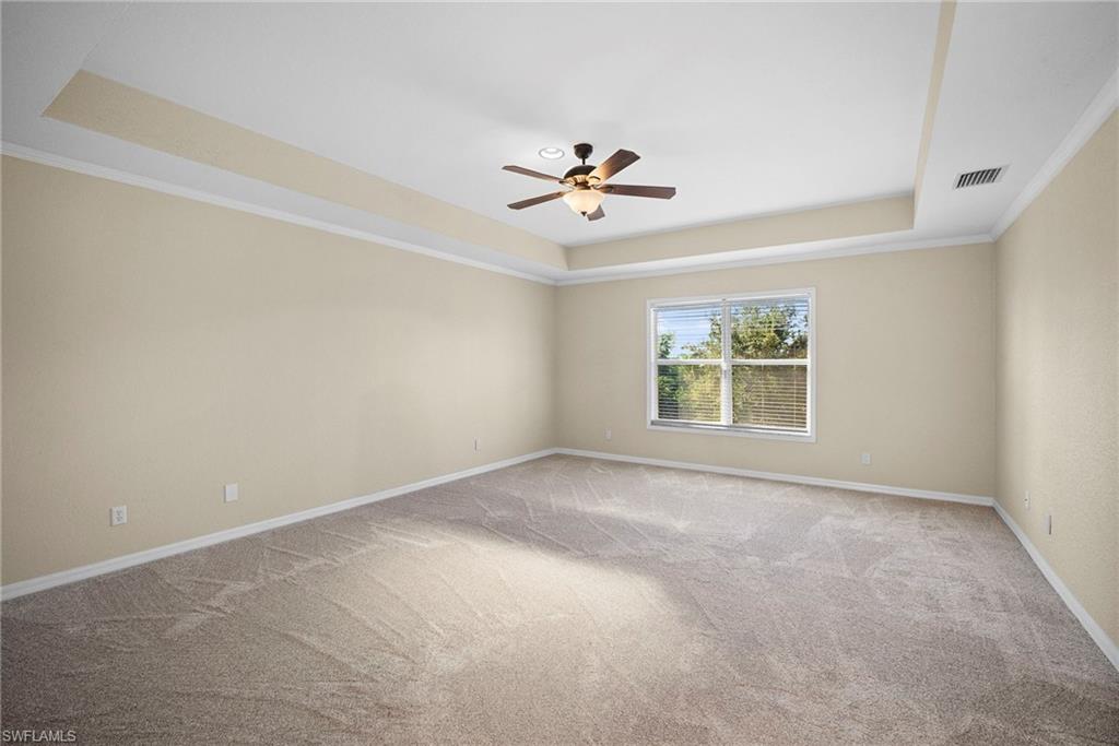 8542 Sumner Avenue, Unit 1 Fort Myers, FL 33908 - Photo 11 of 18 an empty room with windows and ceiling fan