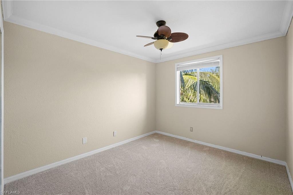 8542 Sumner Avenue, Unit 1 Fort Myers, FL 33908 - Photo 14 of 18 an empty room with a window and a ceiling fan