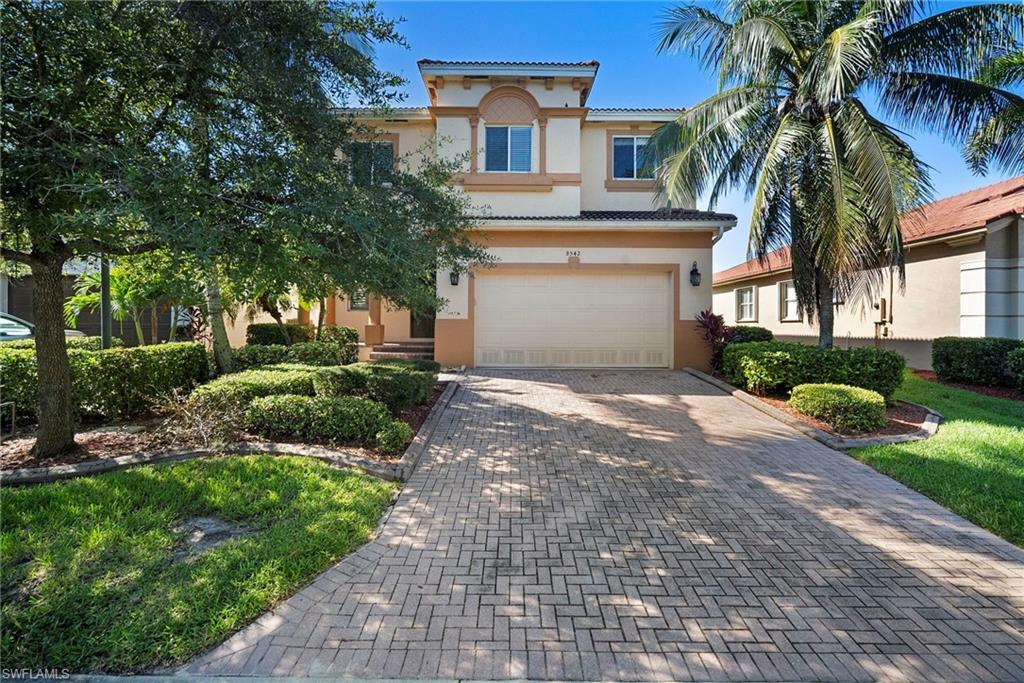 8542 Sumner Avenue, Unit 1 Fort Myers, FL 33908 - Photo 18 of 18 a front view of a house with a yard and potted plants