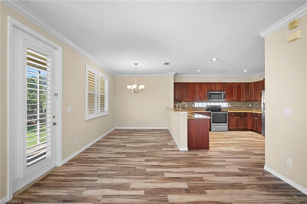 8542 Sumner Avenue, Unit 1 Fort Myers, FL 33908 - Photo 5 of 18 a view of kitchen with cabinets and wooden floor