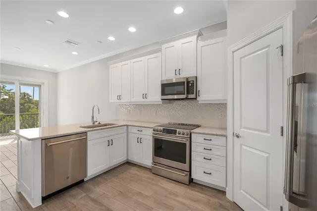 a kitchen with stainless steel appliances granite countertop a stove and a sink