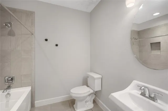 a white toilet sitting next to a bathroom sink