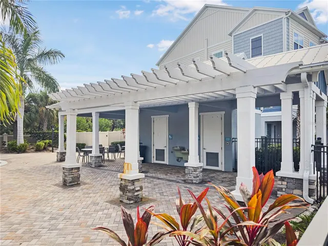 a view of a patio with couches table and chairs and potted plants