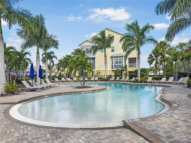 a view of a house with swimming pool and a chairs