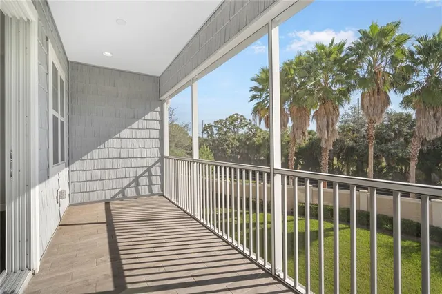 a view of balcony with wooden floor and fence