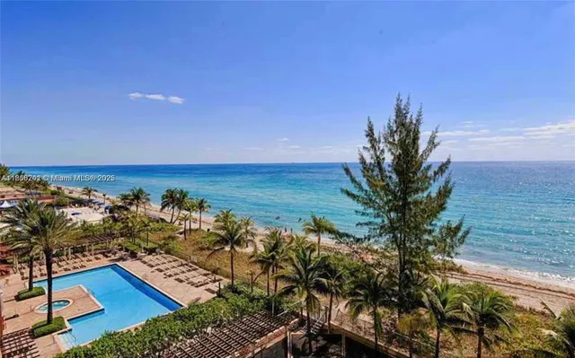 a view of a ocean with a building in the background
