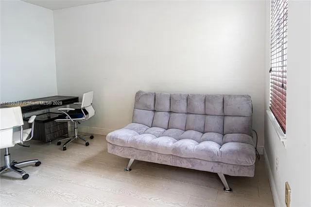 a bedroom with a bed and a chair in it