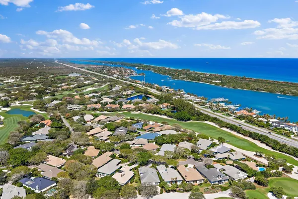 an aerial view of residential houses with outdoor space and trees