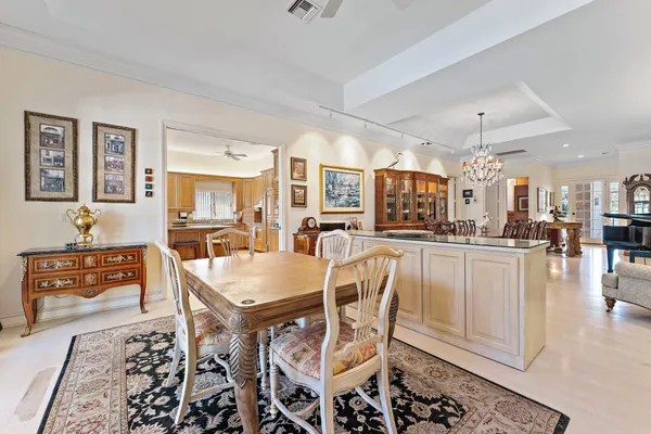a view of a dining room with furniture and chandelier