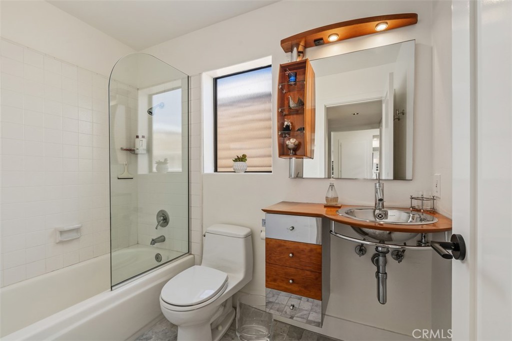 23862 Marmara Bay Dana Point, CA 92629 - Photo 15 of 21 a bathroom with a toilet a sink a mirror a bathtub and shower