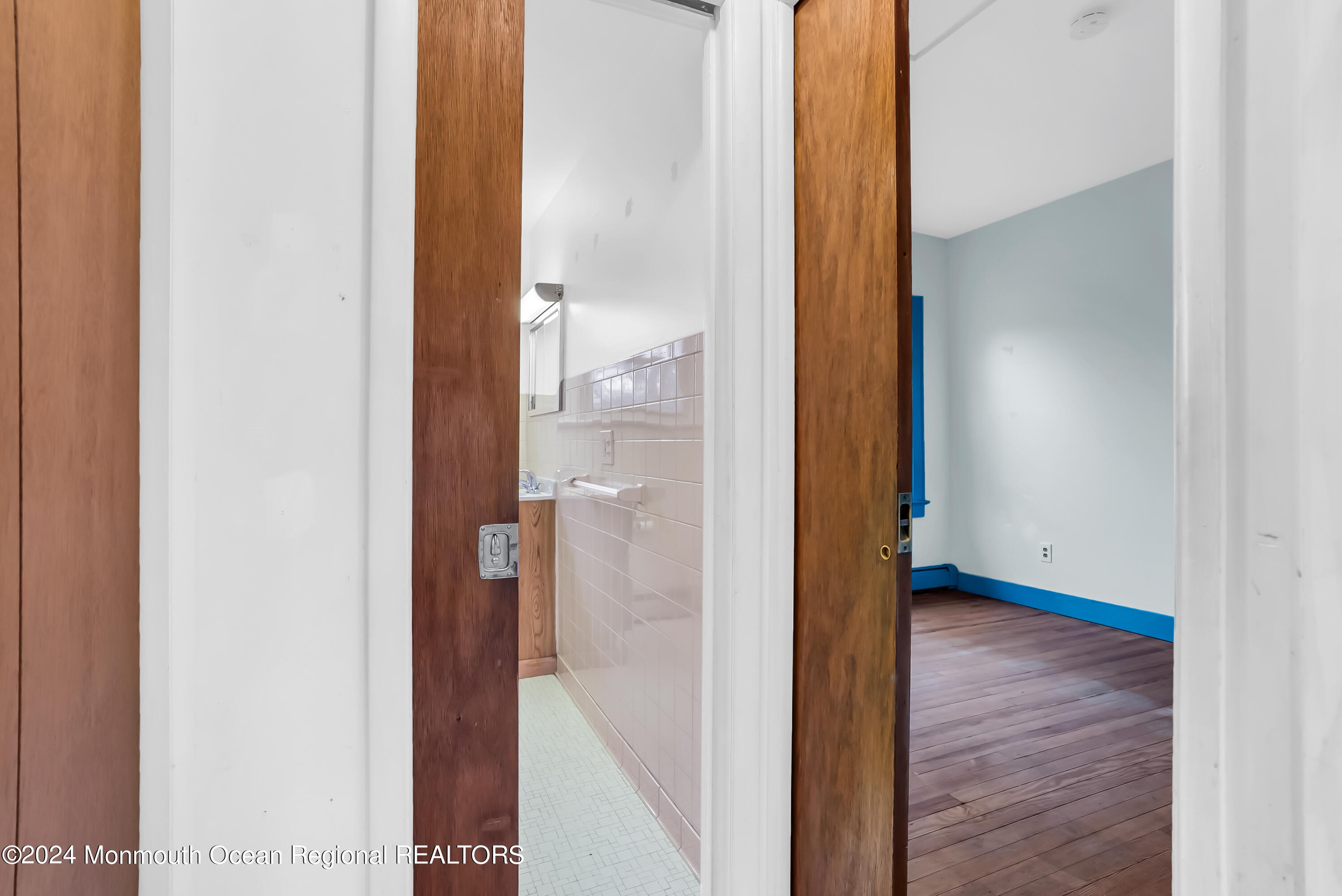 557 Wayside Road Neptune Township, NJ 07753 - Photo 38 of 68 Pocket Doors to 2nd BA & 3rd BR