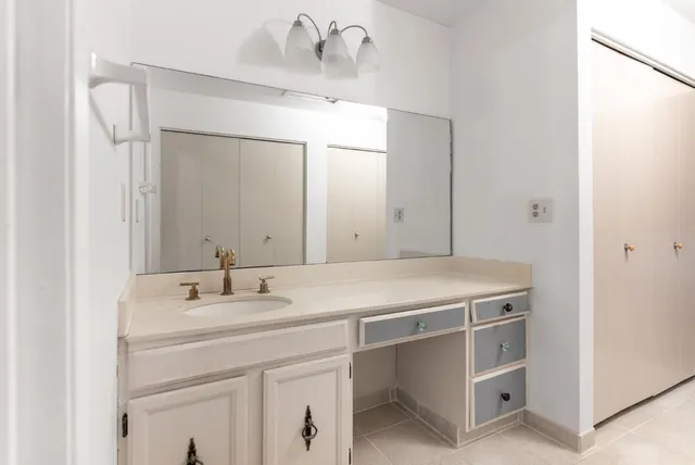 a bathroom with a sink a vanity and a mirror