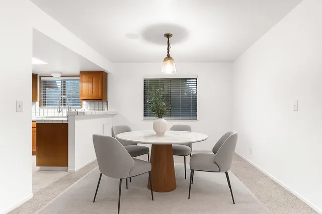 a dining room with furniture and window