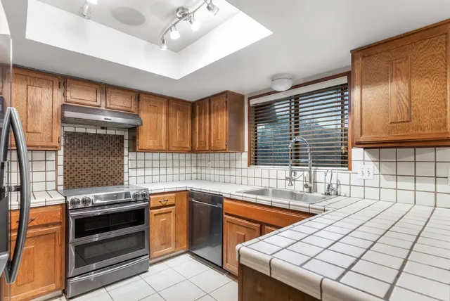 a kitchen with stainless steel appliances and cabinets