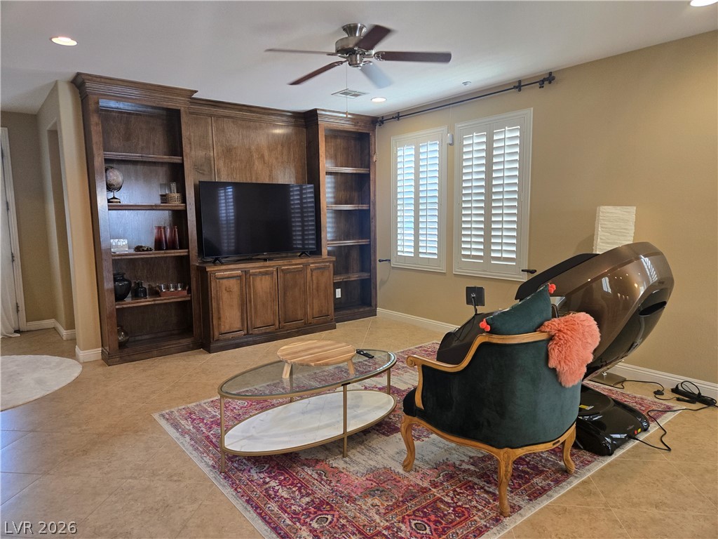 3144 Whitfeild Avenue Henderson, NV 89044 - Photo 48 of 55 Built-in wooden shelving and cabinetry elevate this inviting and well-lit living space.