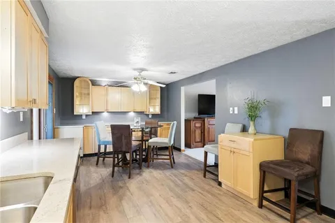 a kitchen with sink cabinets and wooden floor