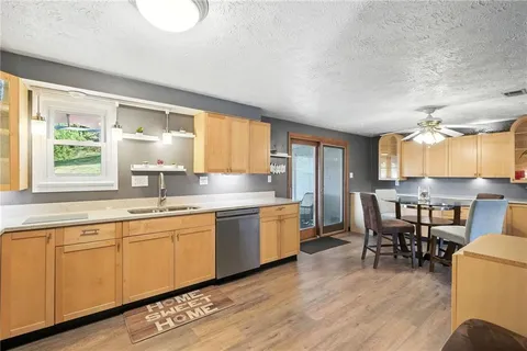 a kitchen with a table chairs refrigerator and cabinets