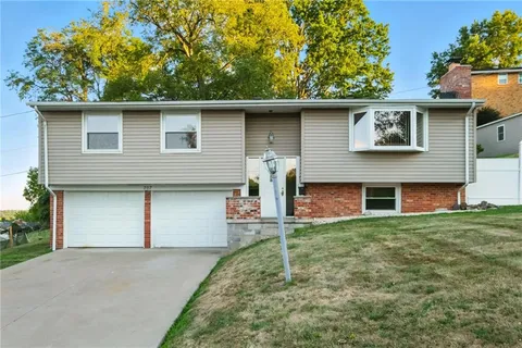 a view of backyard of house with outdoor seating and garage
