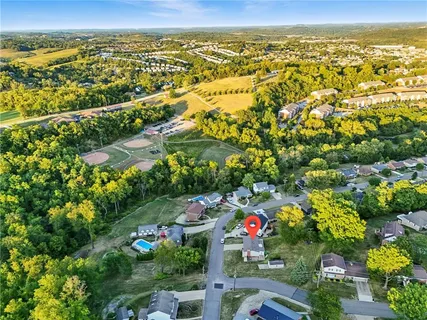 an aerial view of a house with a yard