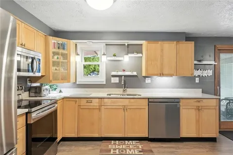 a kitchen with a refrigerator sink and stove