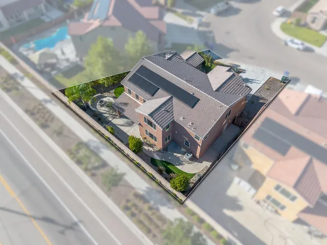 an aerial view of a house with a yard and a garage